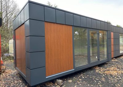 Portable Office 600cm x 300cm (10ft x20ft) – Model 3 – Steel frame 100x100x3 mm; Galvanized external walls in wood color; Roof, walls and floor insulated with 100mm Styrofoam; Aluminum double glazed: door, Aluminum opening window and 2 pcs Aluminum fix windows; electrical installation, wall mounted electric heater